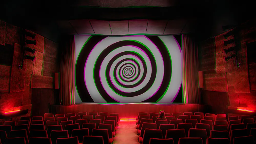A darkened cinema with a giant hypnotic spiral filling the screen and a lone figure in the seats